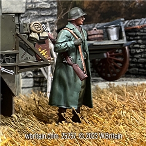 U.S. Infantryman Standing with Raincoat over Equipment