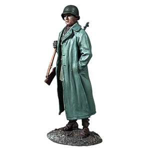 B25257 U.S. Infantryman Standing with Raincoat over Equipment